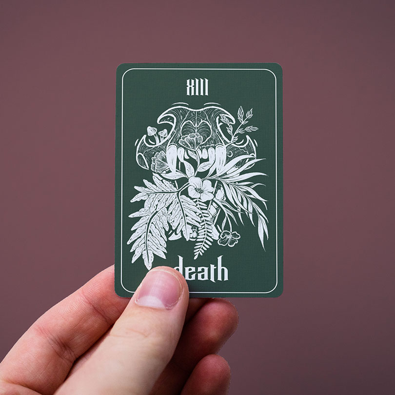 hand holding the death tarot card